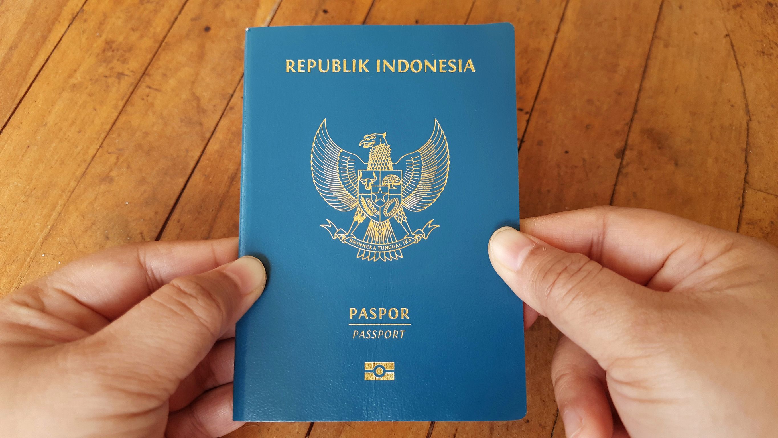 Indonesian Passport Held In Hands