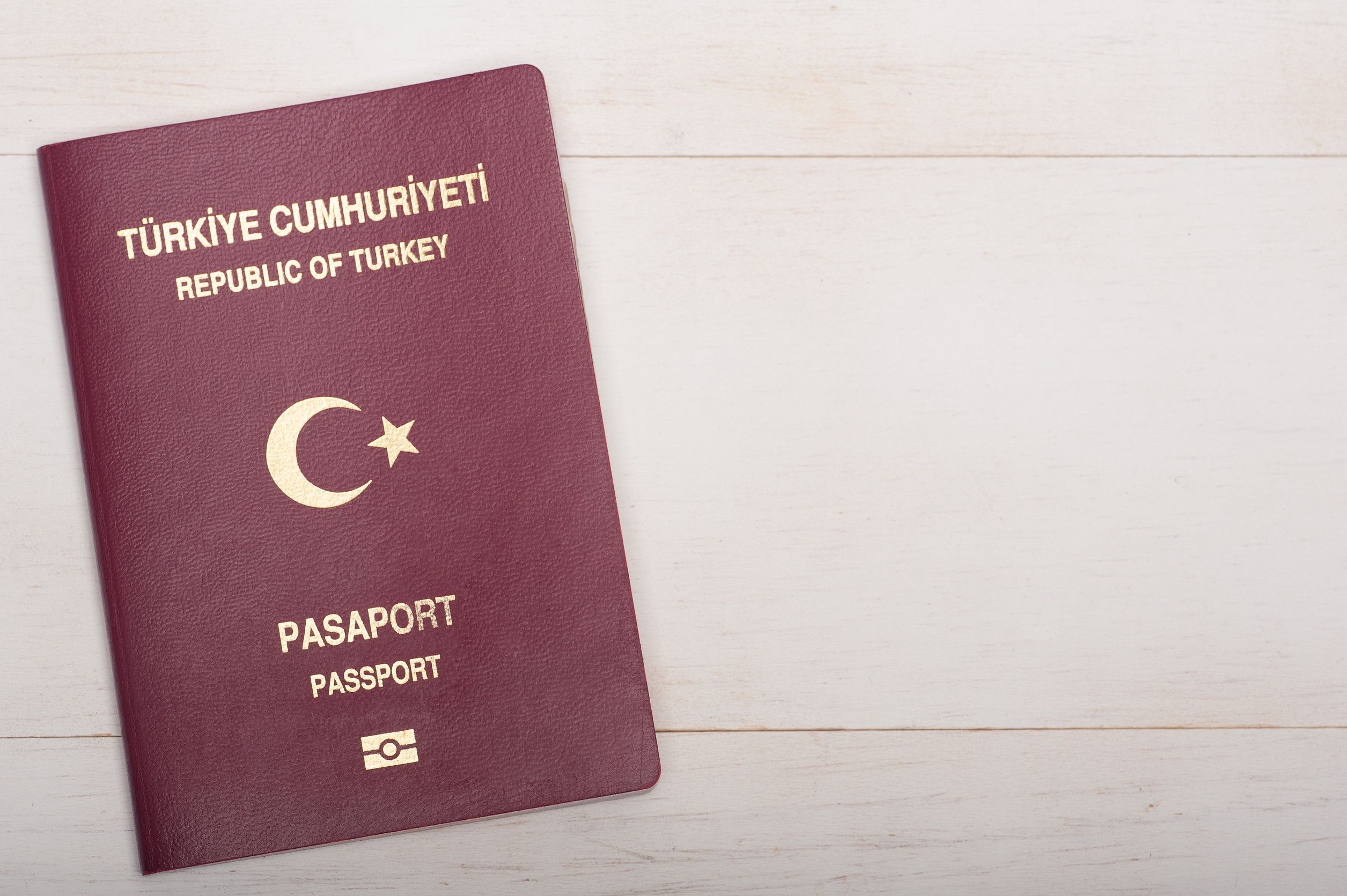 Turkish Passport On White Wooden Background