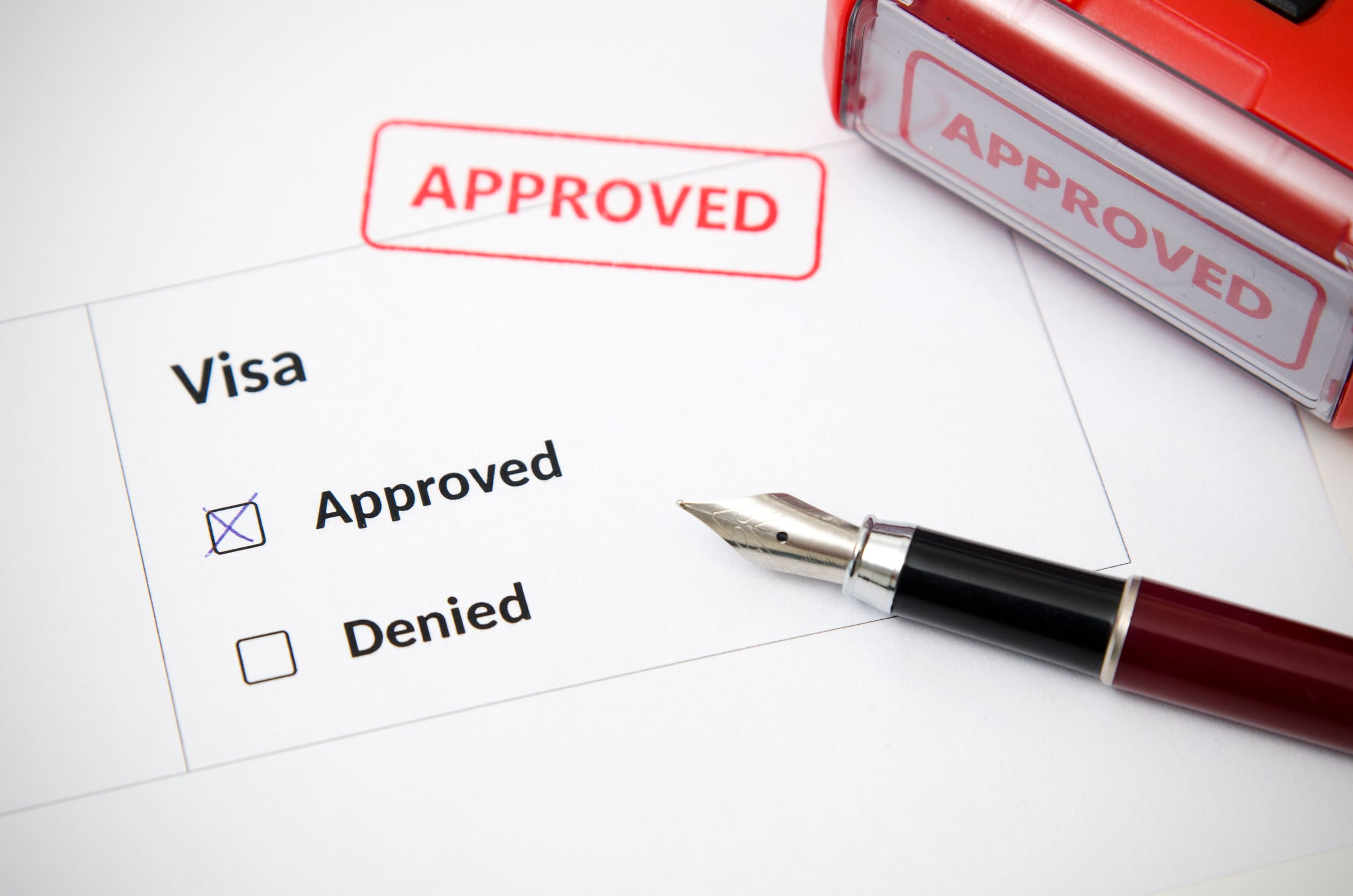 Visa And Approved Stamp On A Document Form Immigration